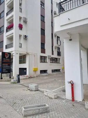 an empty parking lot in front of a building at Apartman Centar LUX in Vrnjačka Banja