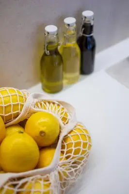 a bag of lemons and two bottles of juice at Sila apartman Vrnjačka Banja in Vrnjačka Banja