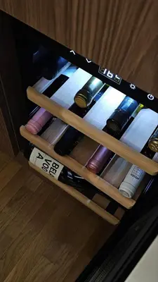 a drawer full of wine bottles in a cabinet at Sila apartman Vrnjačka Banja in Vrnjačka Banja