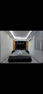 a bedroom with a large black bed in a room at Vila Bosanski Merak in Bujanovac