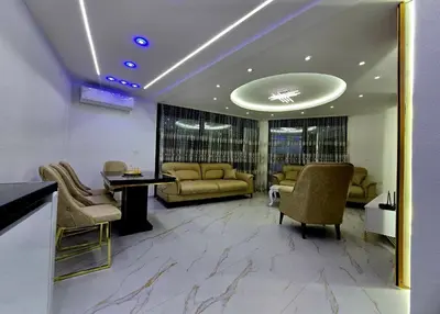 a lobby with couches and a table and chairs at Vila Bosanski Merak in Bujanovac
