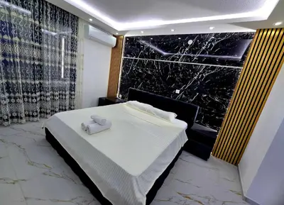 a bedroom with a white bed and a window at Vila Bosanski Merak in Bujanovac