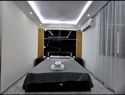 a bedroom with a bed with two towels on it at Vila Bosanski Merak in Bujanovac