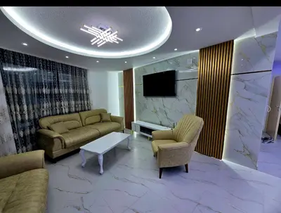 a living room with two couches and a tv at Vila Bosanski Merak in Bujanovac
