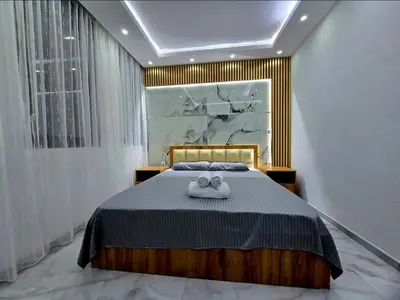 a bedroom with a bed with two towels on it at Vila Bosanski Merak in Bujanovac