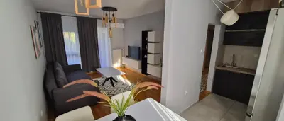 a living room with a couch and a table at 15th Corner Apartment in Niš