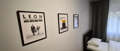 four framed pictures on a wall in a hotel room at 15th Corner Apartment in Niš