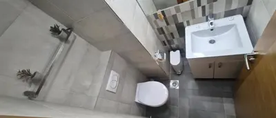 a bathroom with a toilet and a sink at 15th Corner Apartment in Niš