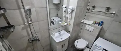 a small bathroom with a sink and a toilet at 15th Corner Apartment in Niš
