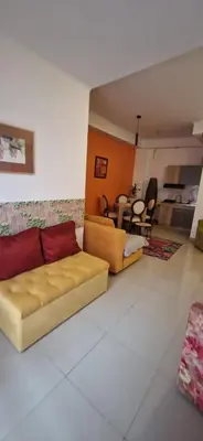 a living room with a couch and a table at Apartmani Pejovic in Niš
