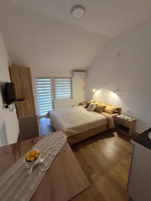 a bedroom with a bed and a bowl of oranges on the floor at Oaza studio 1 in Soko Banja