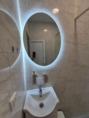 a bathroom with a white sink and a mirror at Oaza studio 1 in Soko Banja