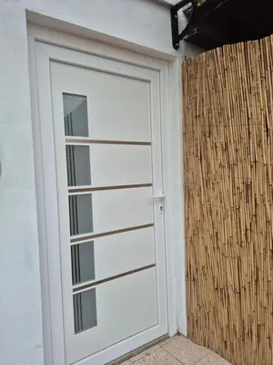 a white garage door on the side of a building at Oaza studio 1 in Soko Banja