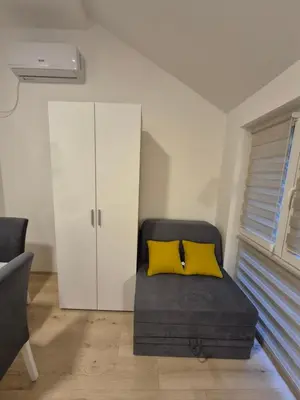 a bed with two yellow pillows in a room at Oaza studio 2 in Soko Banja
