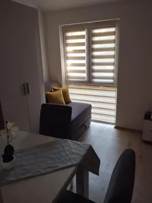 a living room with a couch and a window at Oaza studio 2 in Soko Banja