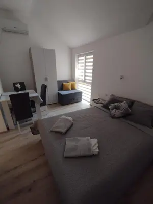 a bedroom with a large bed with two towels on it at Oaza studio 2 in Soko Banja