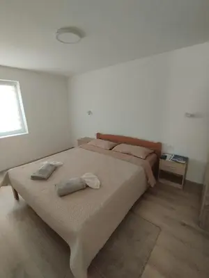 a bedroom with a bed with two towels on it at Oaza apartman in Soko Banja