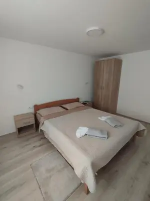 a bedroom with a bed with two towels on it at Oaza apartman in Soko Banja