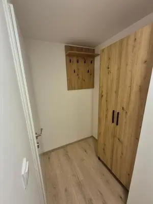 a room with a large wooden door in a room at Oaza apartman in Soko Banja