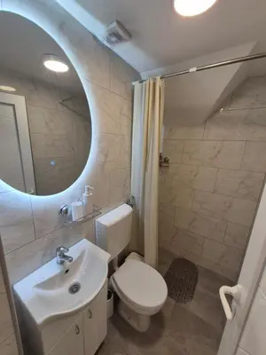 a bathroom with a white toilet and a sink at Oaza apartman in Soko Banja