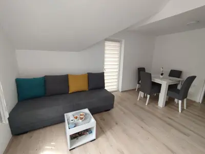a living room with a couch and a table at Oaza apartman in Soko Banja