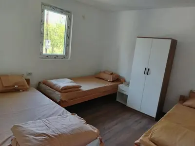 a room with two beds and a mirror in it at Смештај Вероника и Симона