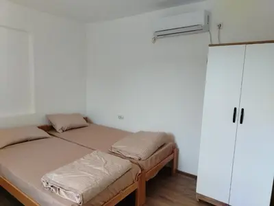 a bedroom with two beds and a closet at Смештај Вероника и Симона