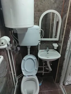 a bathroom with a toilet and a sink at Смештај Вероника и Симона