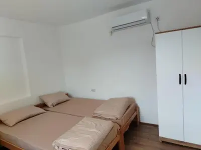 a bedroom with two beds and a refrigerator at Смештај Вероника и Симона