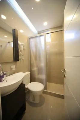 a bathroom with a toilet and a sink and a shower at Agent Lux Apartments in Jagodina