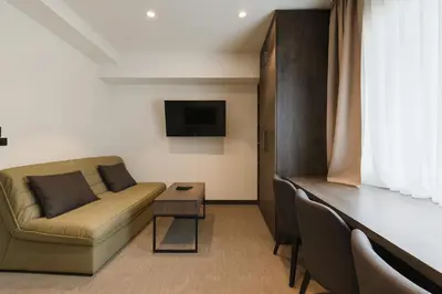 a living room with a couch and a table at Central Konaci Apartments & Studio by Husky in Kopaonik