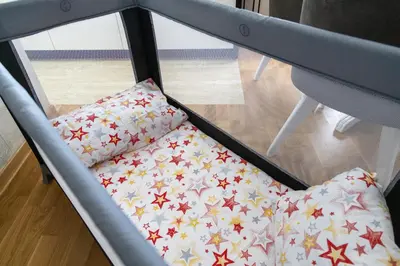 a bed with a pillow with stars on it at Apartman Sunce Lux N in Vrnjačka Banja