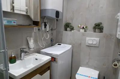 a small bathroom with a sink and a toilet at Apartman Sunce Lux N in Vrnjačka Banja
