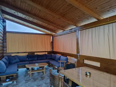 a living room with a blue couch and a table at Brvnara Luni in Kruševac