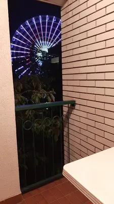 a lit up ferris wheel in a building at Apartman Jezero in Vrnjačka Banja