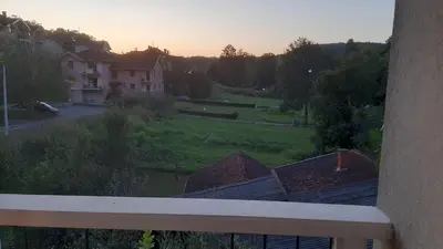 a view of a yard from a balcony of a house at Apartman Jezero in Vrnjačka Banja