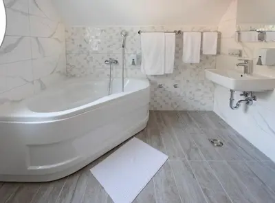 a white bathroom with a tub and a sink at Hotel Bela Jela in Lukovo