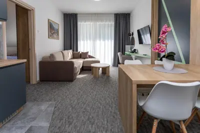 a living room with a couch and a table at Hotel Bela Jela in Lukovo