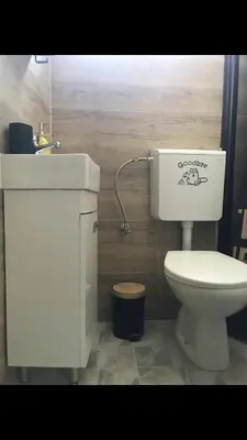 a bathroom with a white toilet and a sink at Riseup apartman in Niš