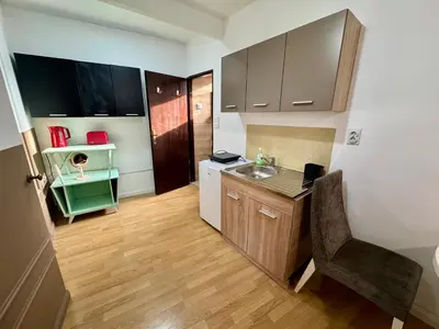 a small kitchen with a sink and a counter at Riseup apartman in Niš