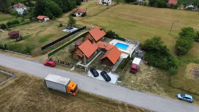 an overhead view of a house with cars parked in front of it at Vikendice Jovicic in Bukorovac