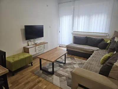 a living room with a couch and a flat screen tv at Apartman Marija II in Vrnjačka Banja