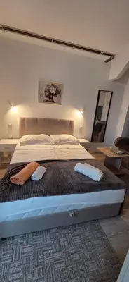 a bedroom with a large bed with two towels on it at Studio Trajkovic in Vranje