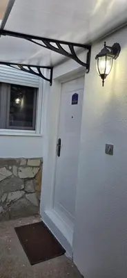 a white door with a light next to a building at Studio Trajkovic in Vranje