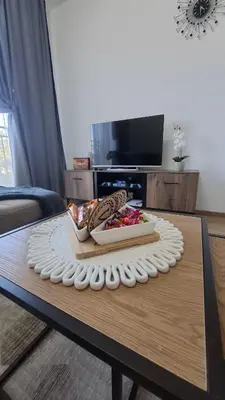 a table with a tray of food on top of it at Apartman Srećko Lux in Vrnjačka Banja