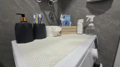 a white washing machine with items on top of it at Apartman Srećko Lux in Vrnjačka Banja