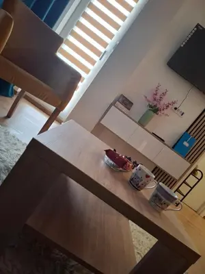 a table in a living room with two cups on it at Apartman Jelena AS in Vrnjačka Banja