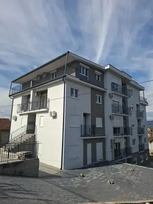 a white building with balconies on the side of it at Apartman Jelena AS in Vrnjačka Banja