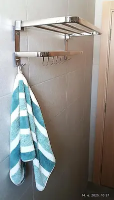 a towel rack with blue and white towels on it at Apartman Orhideja in Vrnjačka Banja