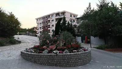 a large flower bed in front of a building at Apartman Orhideja in Vrnjačka Banja
